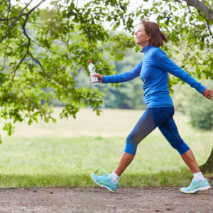 Woman over 50 walking outdoors in natural light